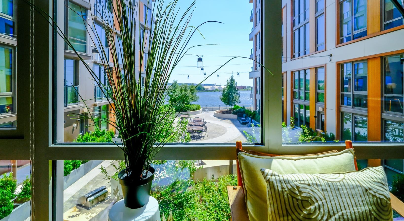 The essence of exceptional living large apartment windows with courtyard and water views