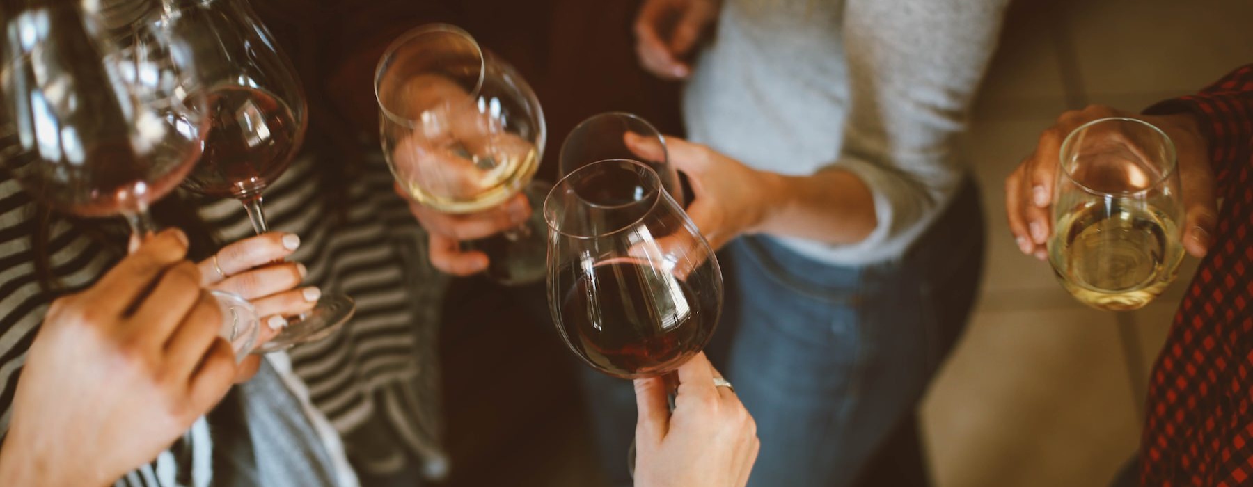 a group of people holding wine glasses