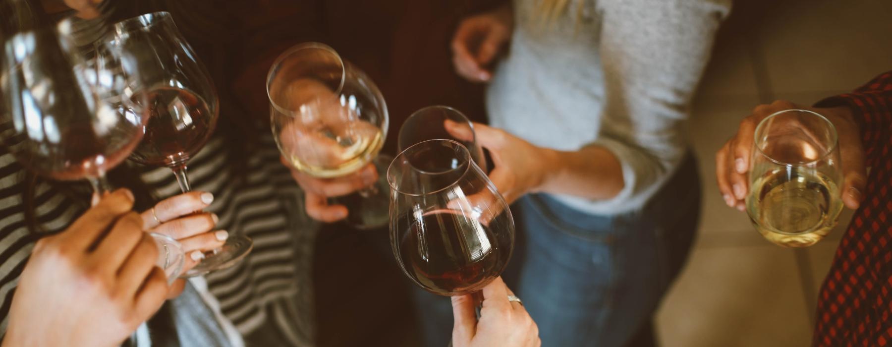 a group of people holding wine glasses