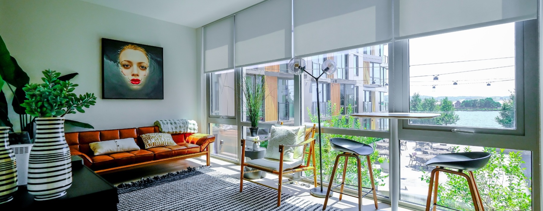 bright floor-to-ceiling windows in sun-filled living room