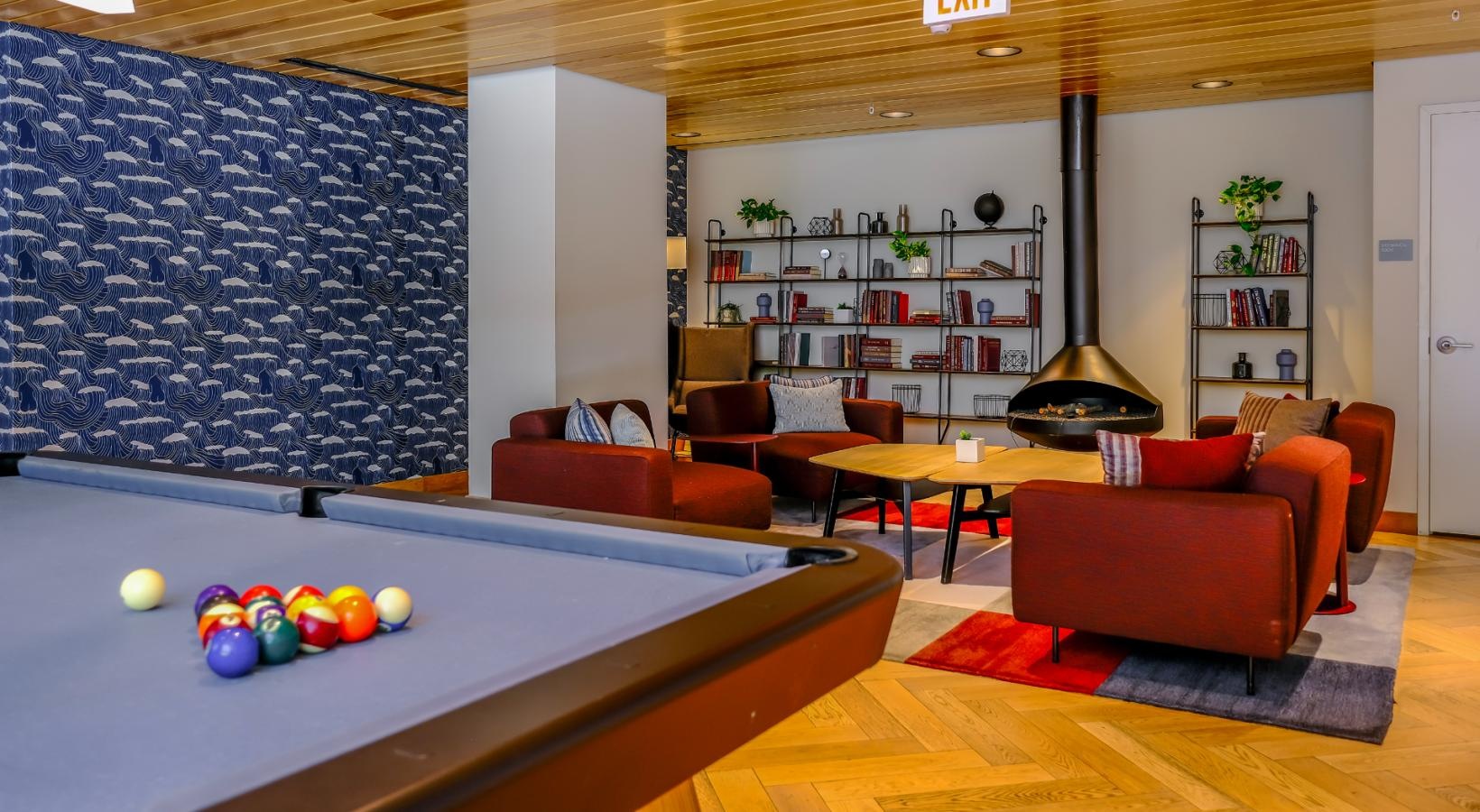 Access to resident-only features recessed lighting in clubhouse with billiards table