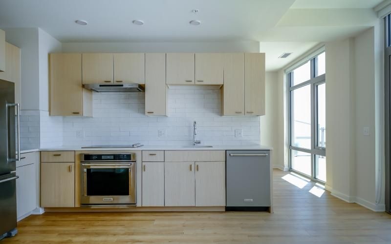 a kitchen  wall with white cabinets