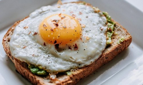 Bustling community with plenty of dining choices a breakfast sandwich with an egg on top