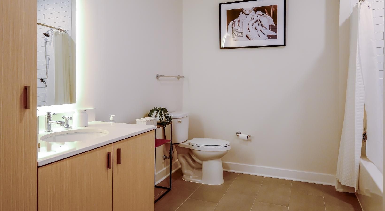 Spacious bathrooms with everything you need well lit bathroom with shower/tub combo