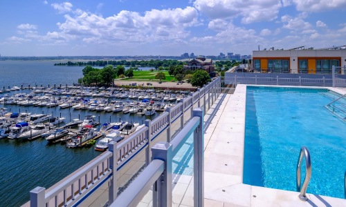 Shimmering resort-style pool rooftop pool with marina views