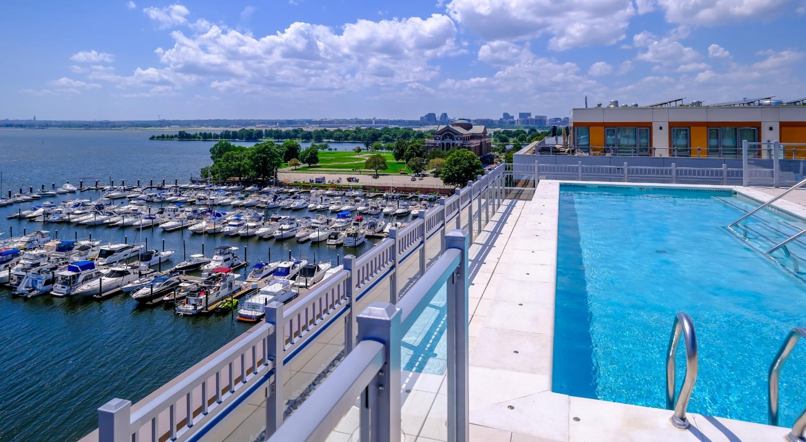 Shimmering resort-style pool rooftop pool with marina views