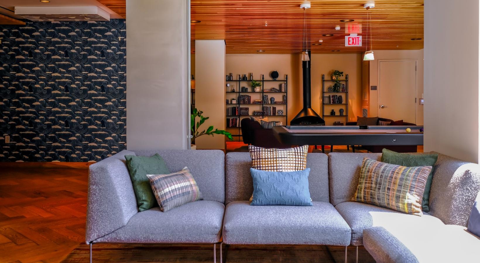 Access to resident-only features sectional in clubhouse near large window